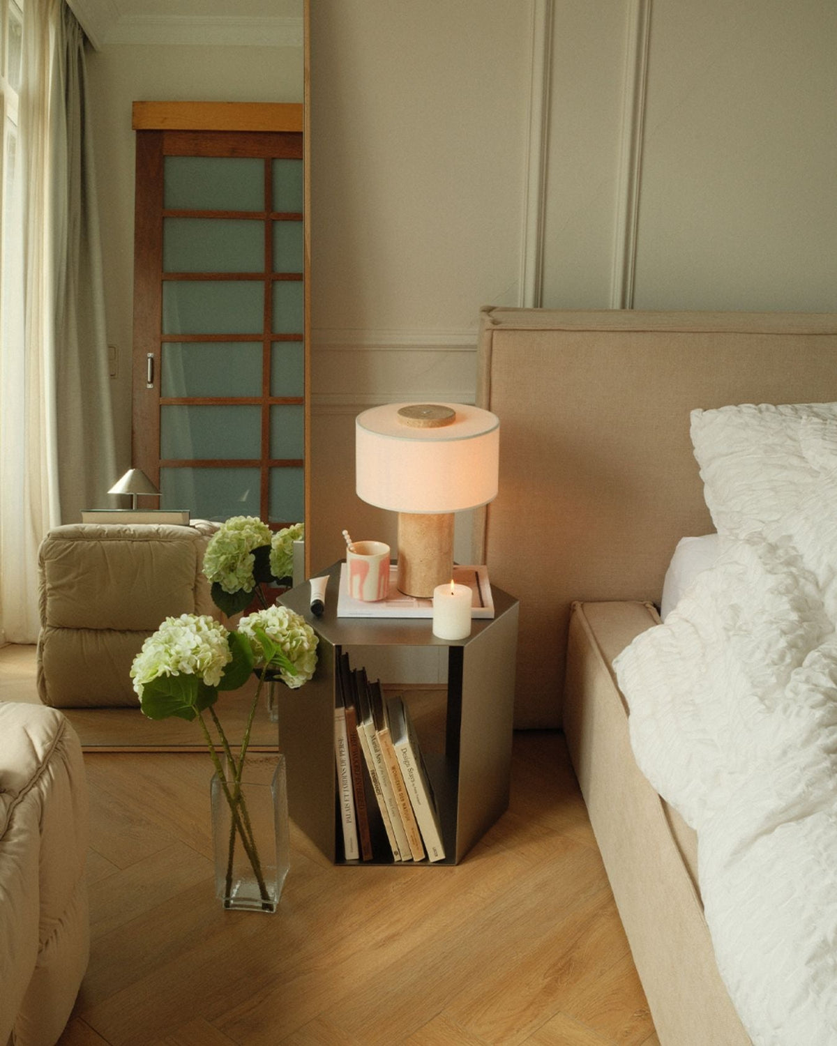 Oriel Travertine Table Lamp on a tray beside a bed