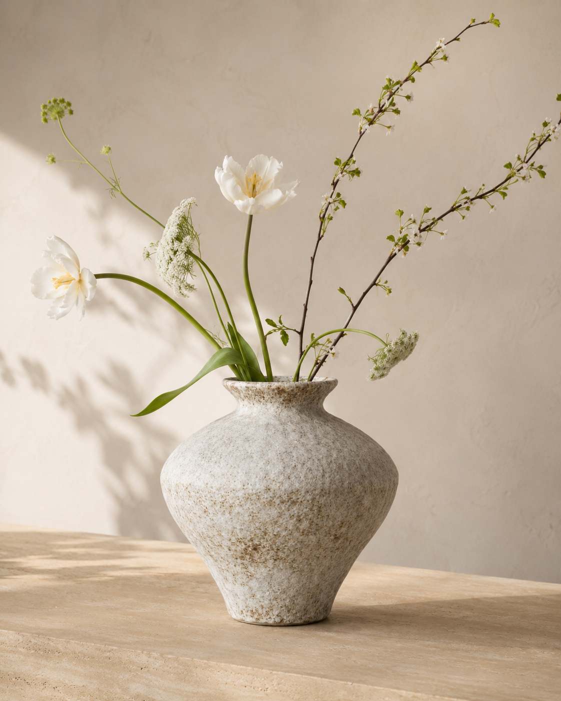Thea Speckle Vase with stems on a tabletop