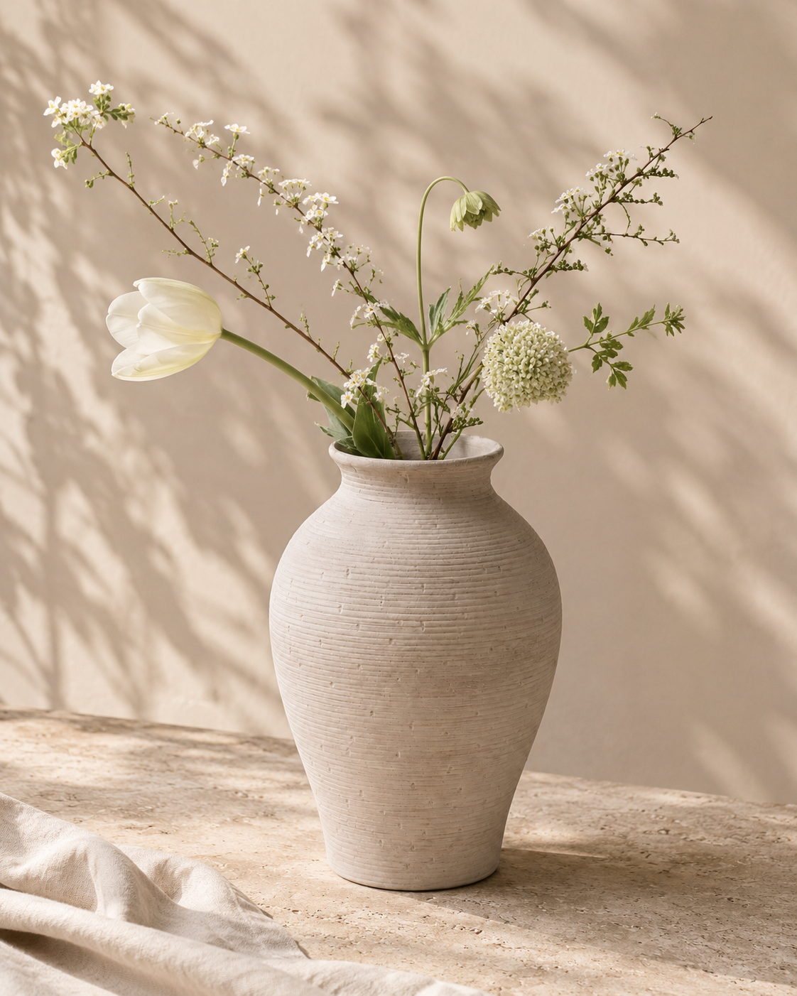 Olia Contour Vase with stems on a tabletop