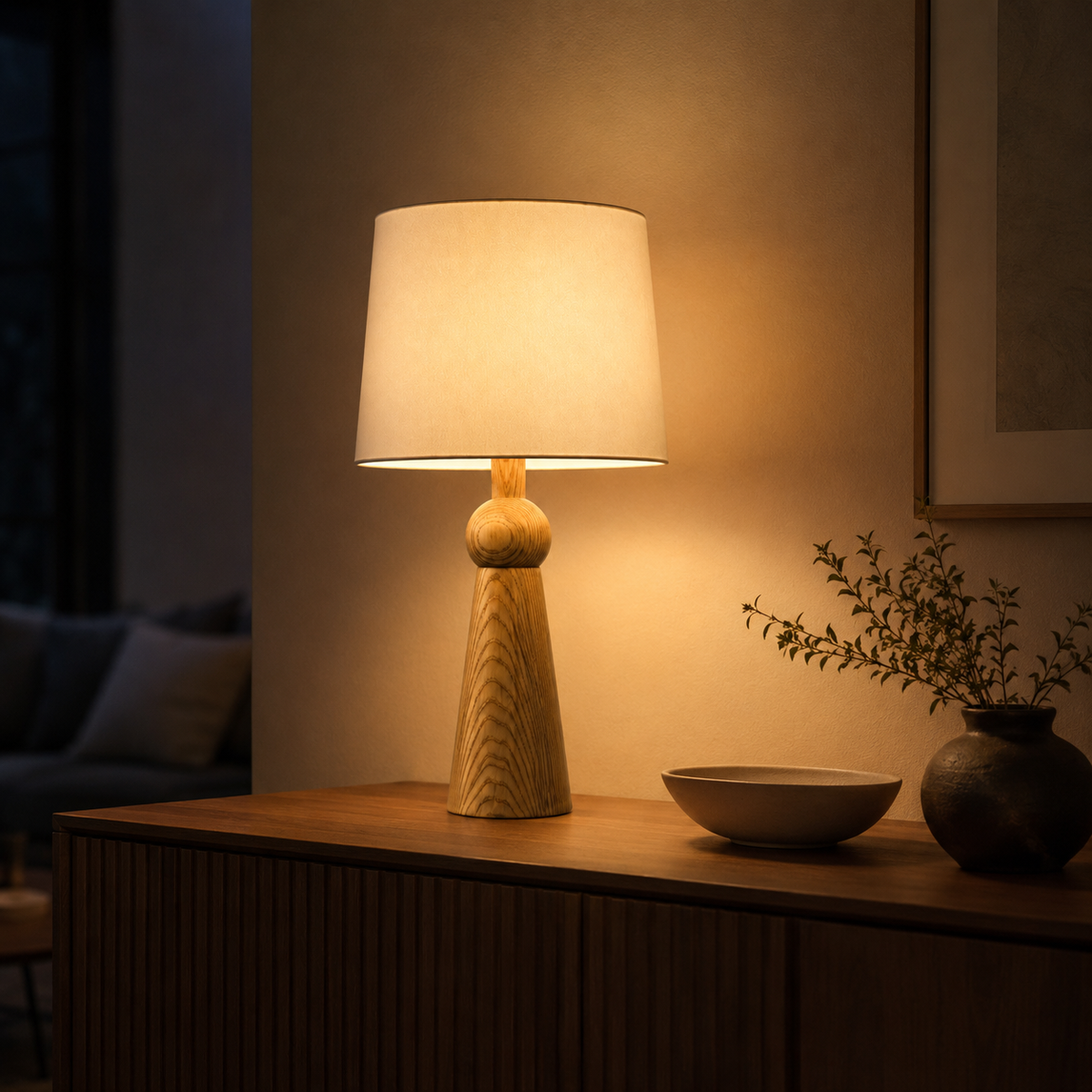 Noelle Bedside Table Lamp glowing in an evening interior