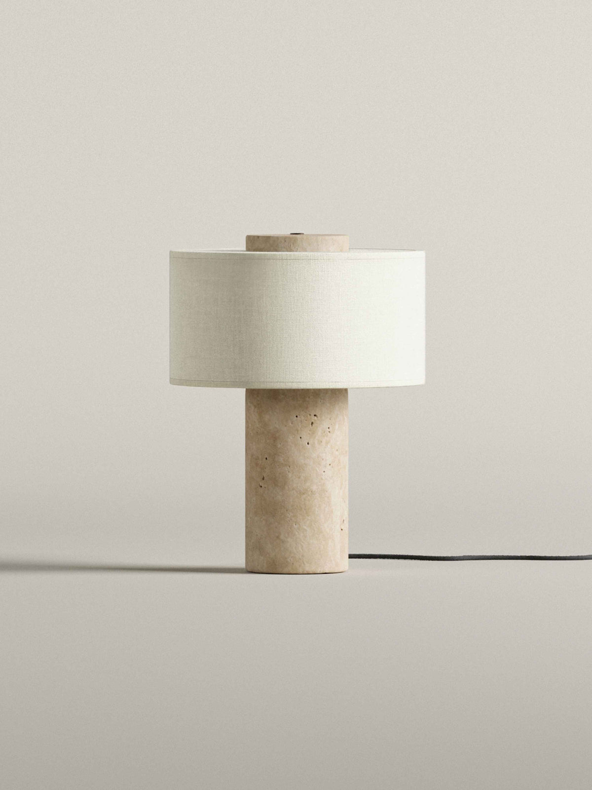 Oriel Travertine Table Lamp unlit on a plain surface