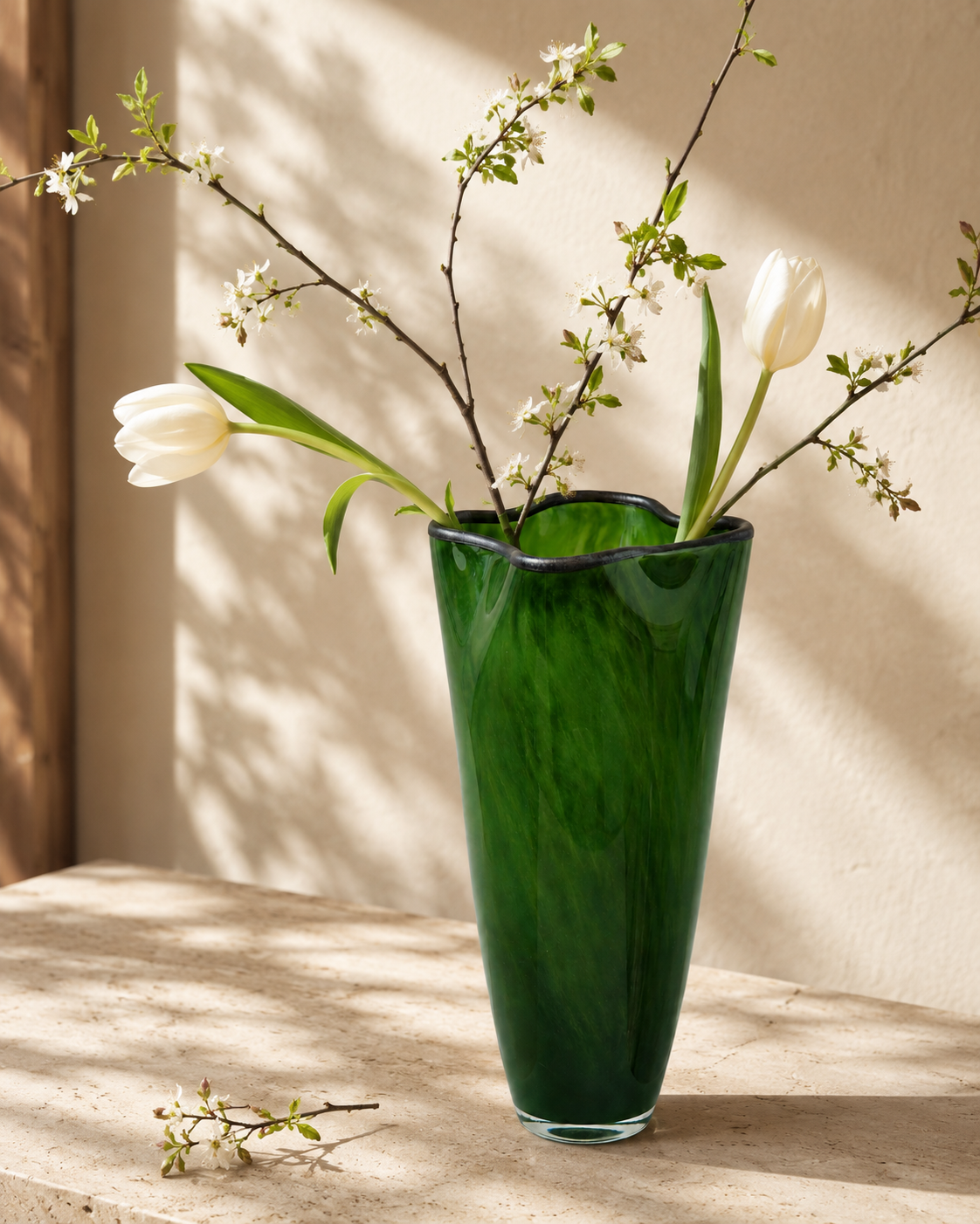 Nela Emerald Vase with stems on a tabletop