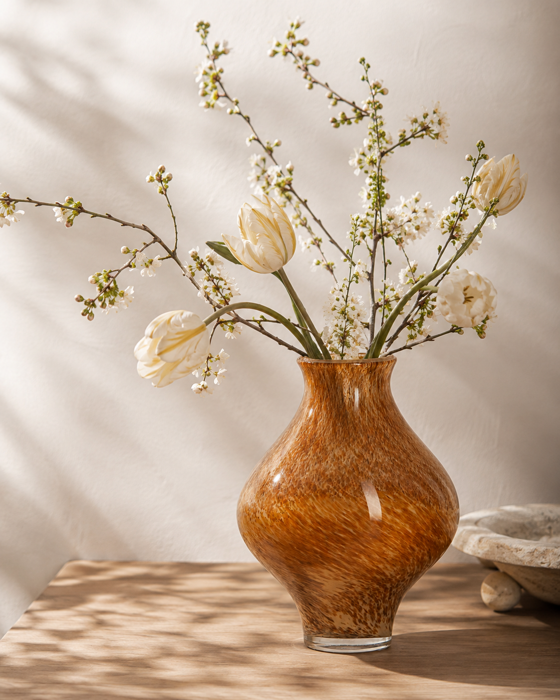 Nela Honey Vase with stems on a tabletop