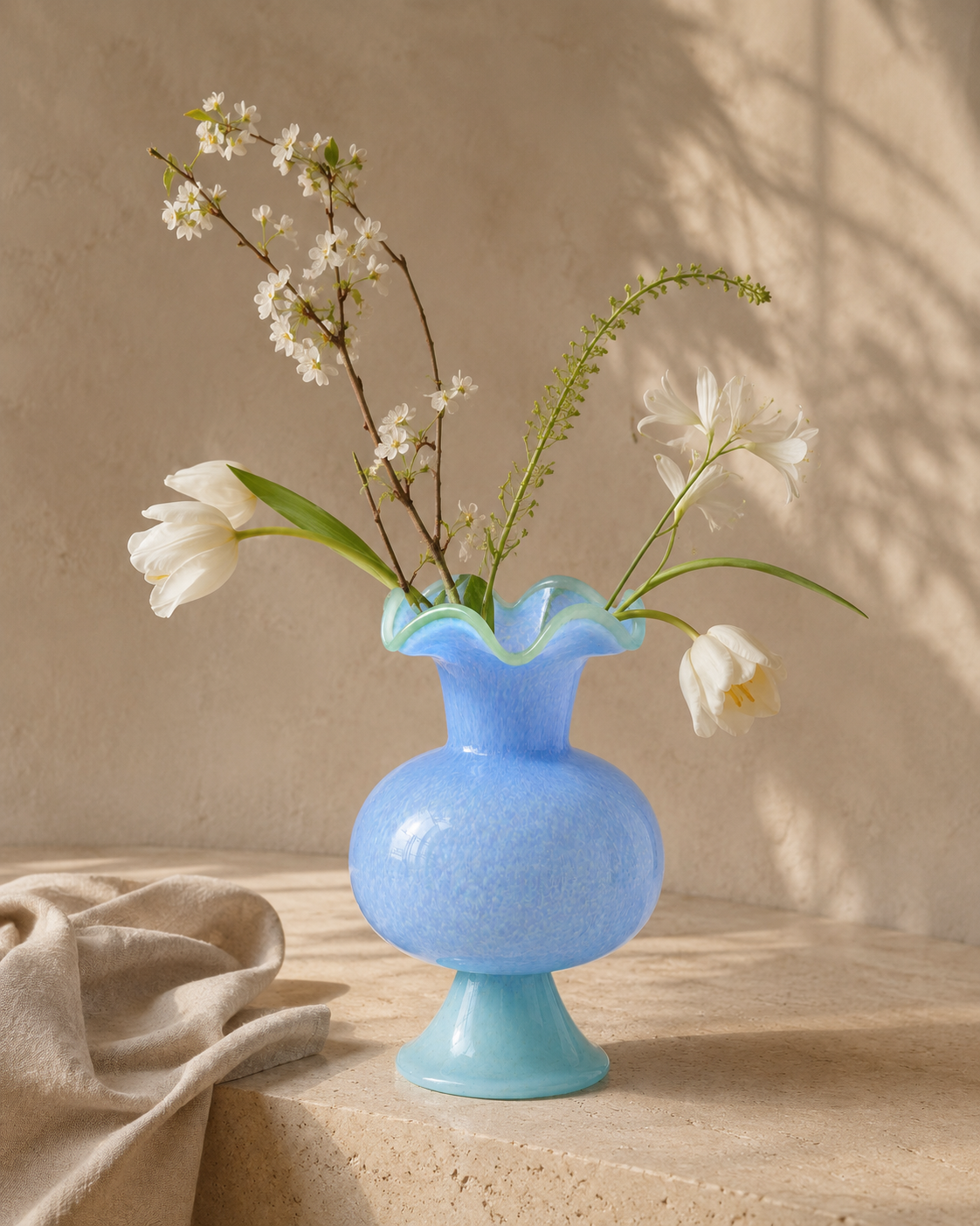 Nela Azure Vase with stems on a tabletop