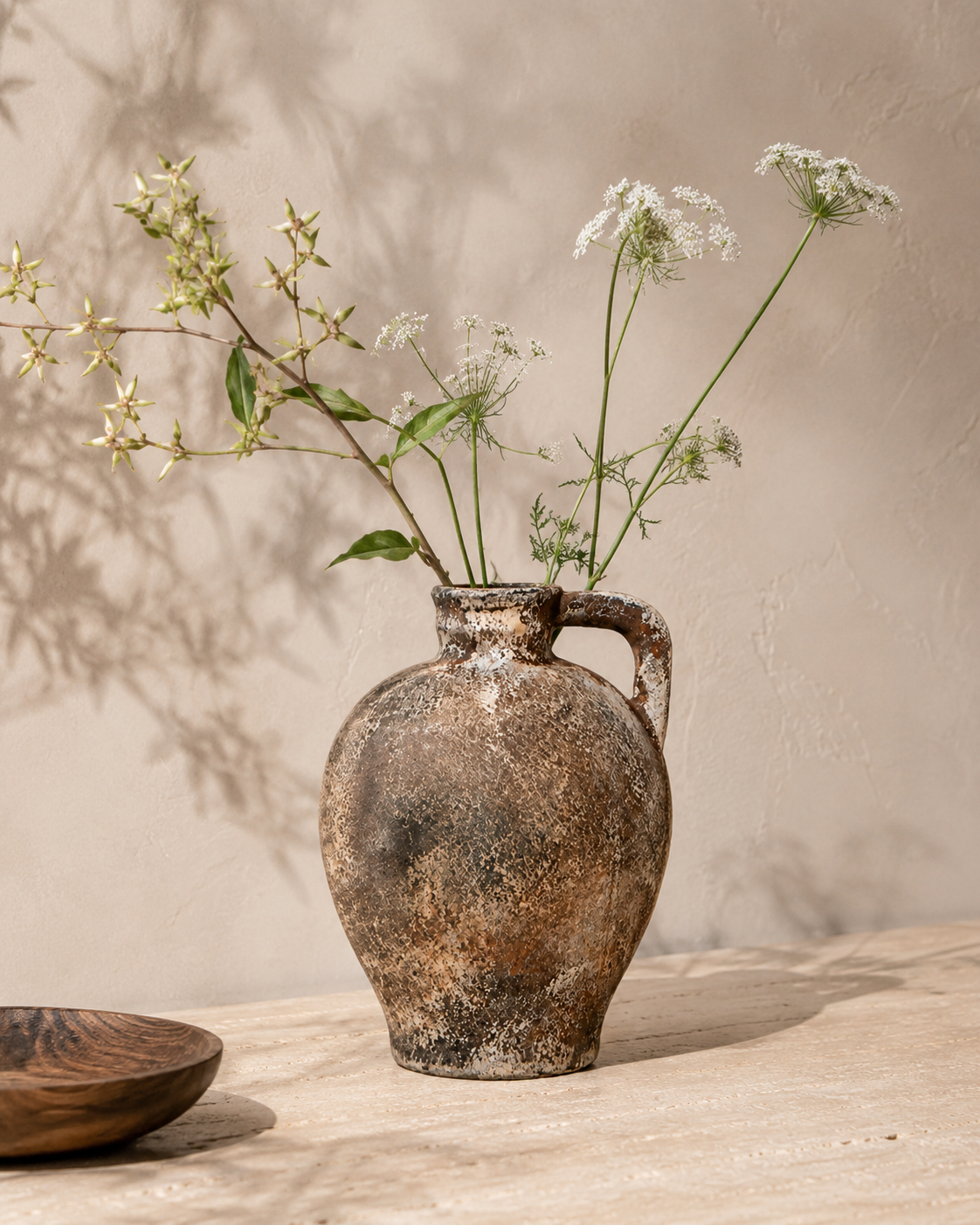 Evia Handle Vase with stems on a tabletop