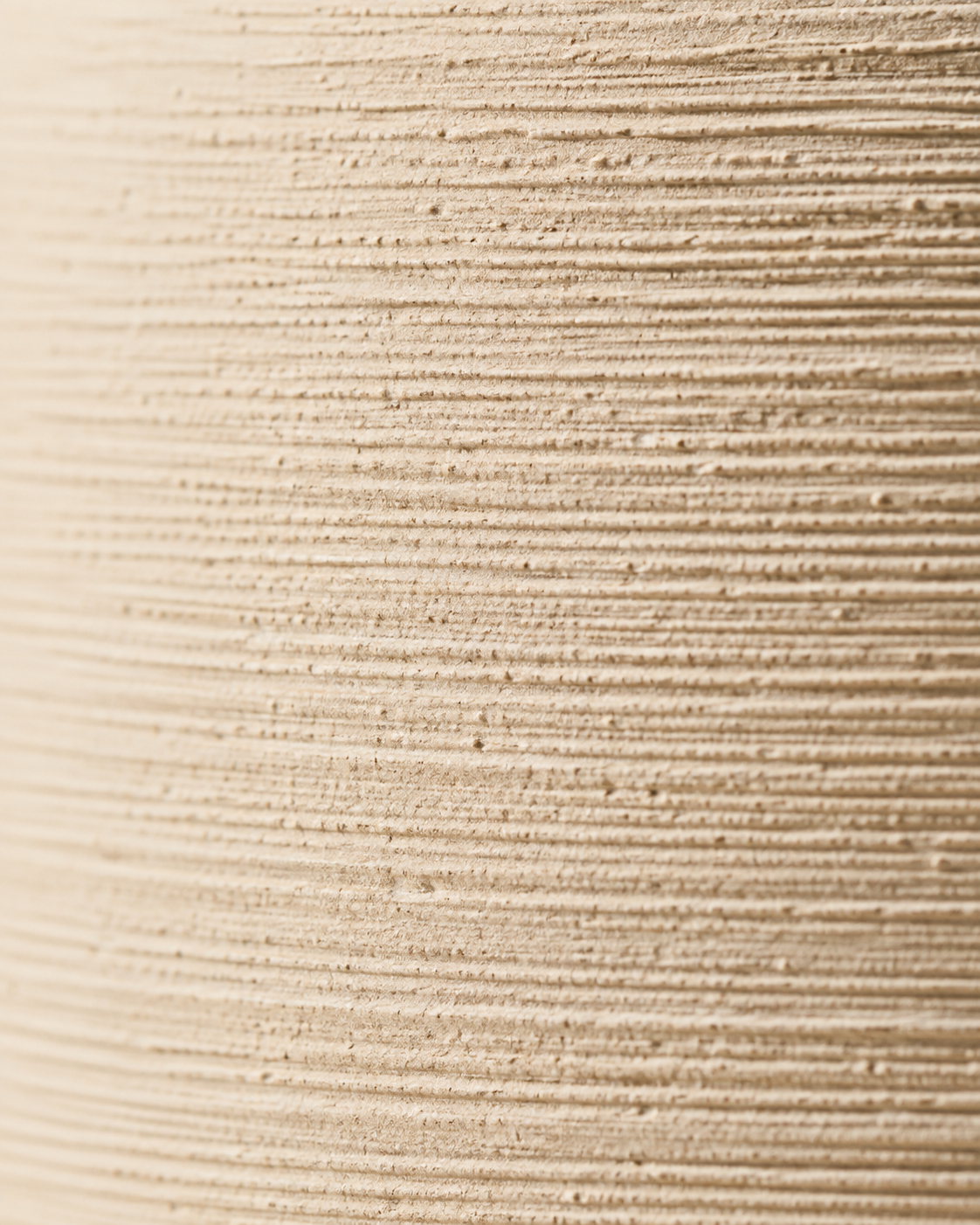 Riva Ridged Vase close-up showing fine horizontal ridges in an ivory tone