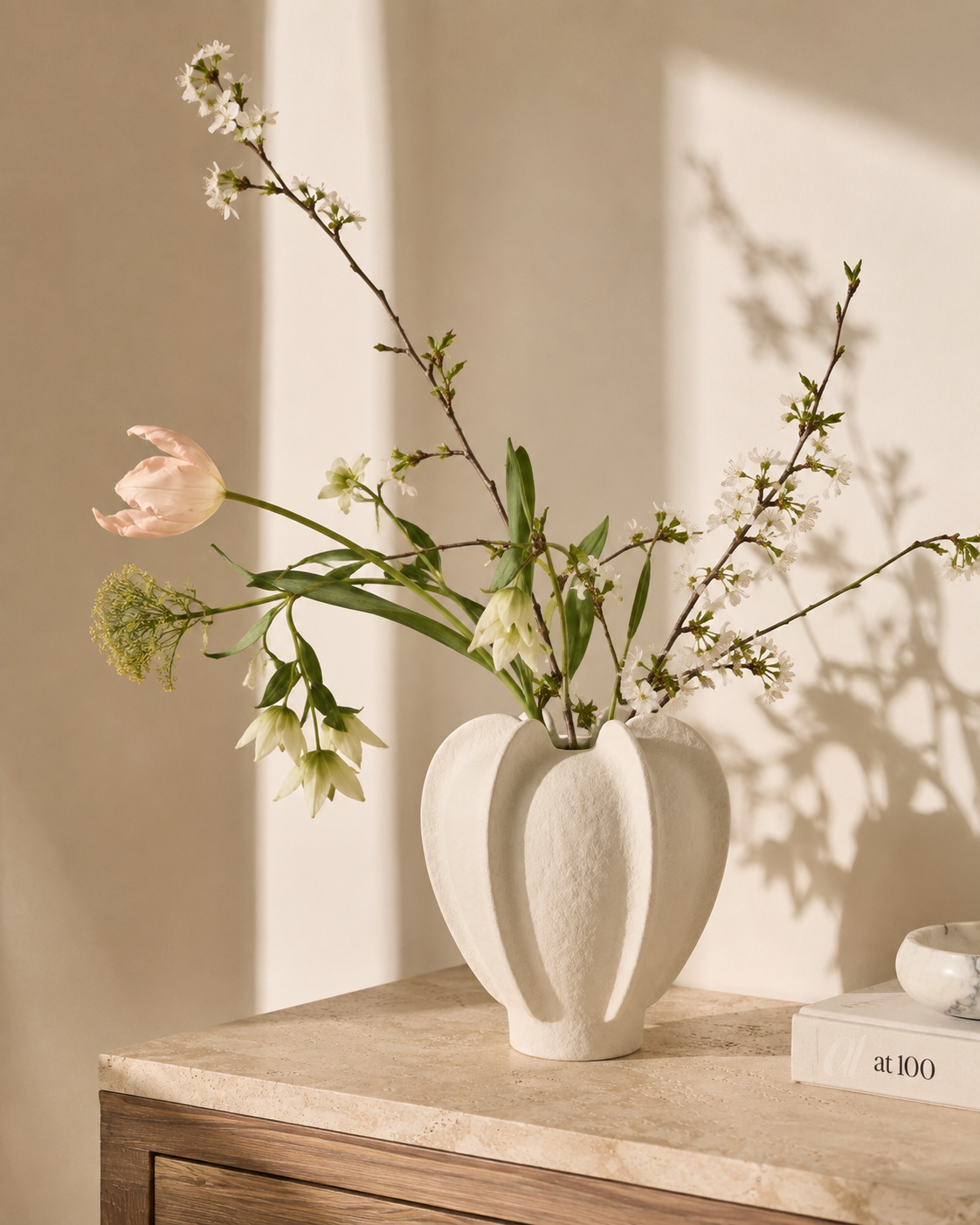 Thea Petal Vase with stems on a tabletop