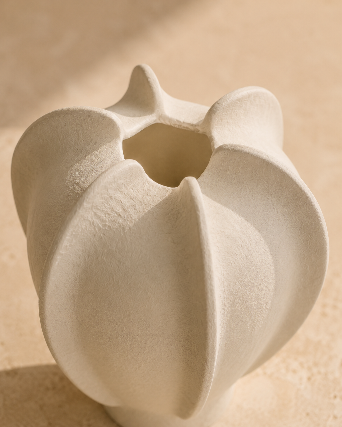 Thea Petal Vase close-up of the curved ivory fins and petal-like opening