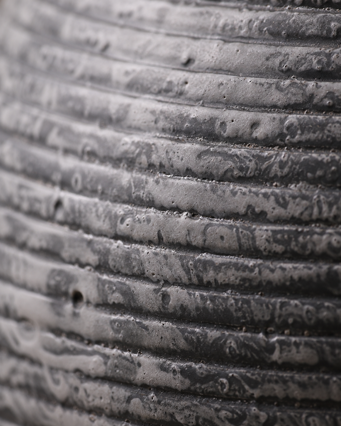Riva Charcoal Vase close-up showing charcoal tone with pale horizontal ridges