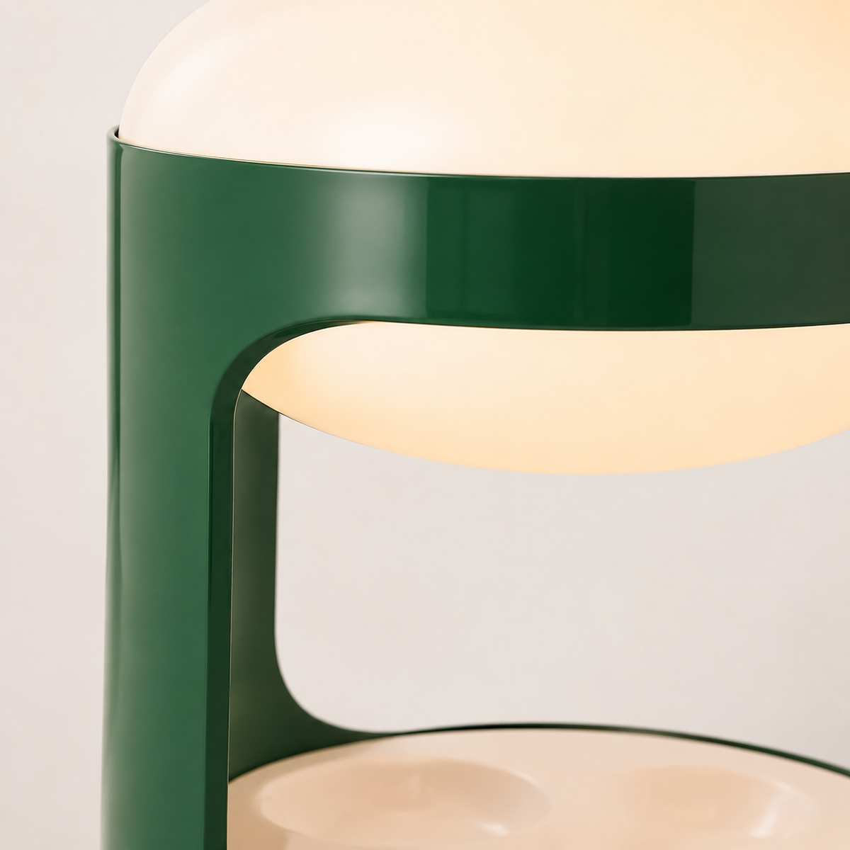 Suri Sculptural Table Lamp green frame surrounding the pale diffuser