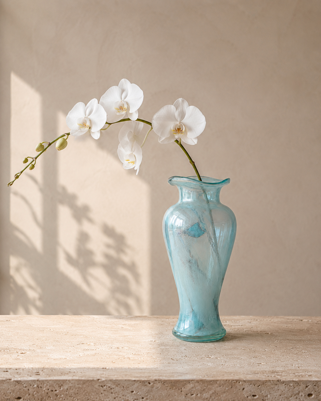 Nela Aqua Vase with stems on a tabletop