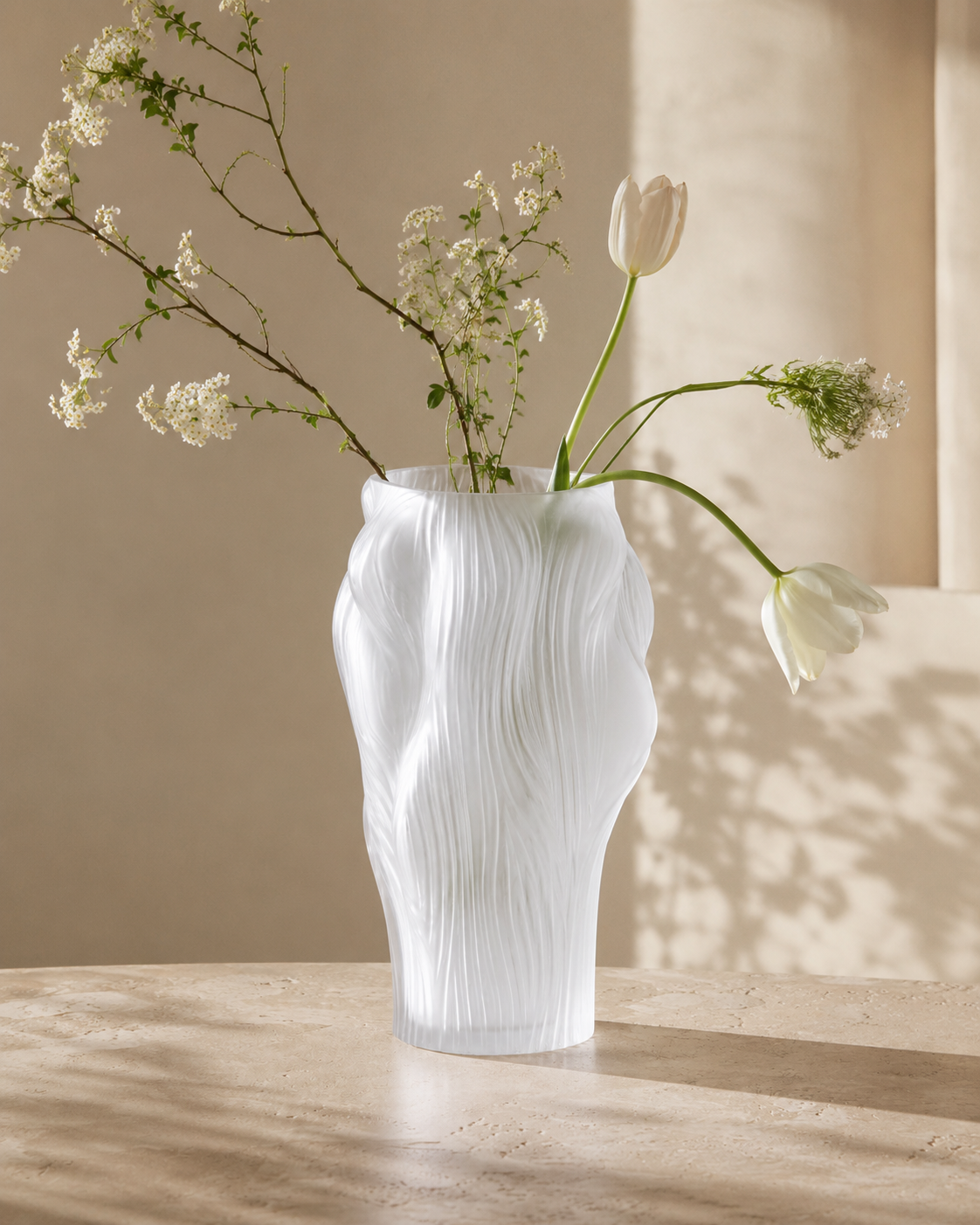 Sora Flow Vase with stems on a tabletop