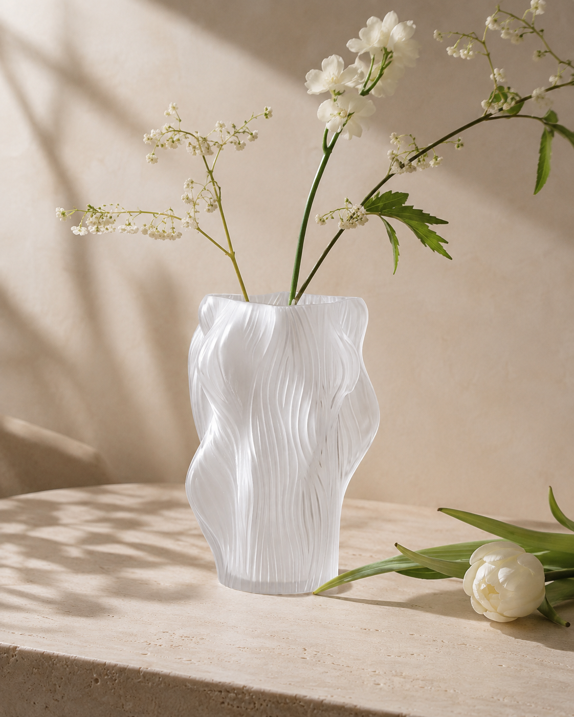 Olia Wave Vase with stems on a tabletop