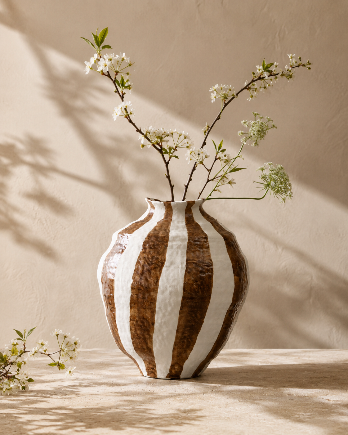 Evia Stripe Vase with stems on a tabletop