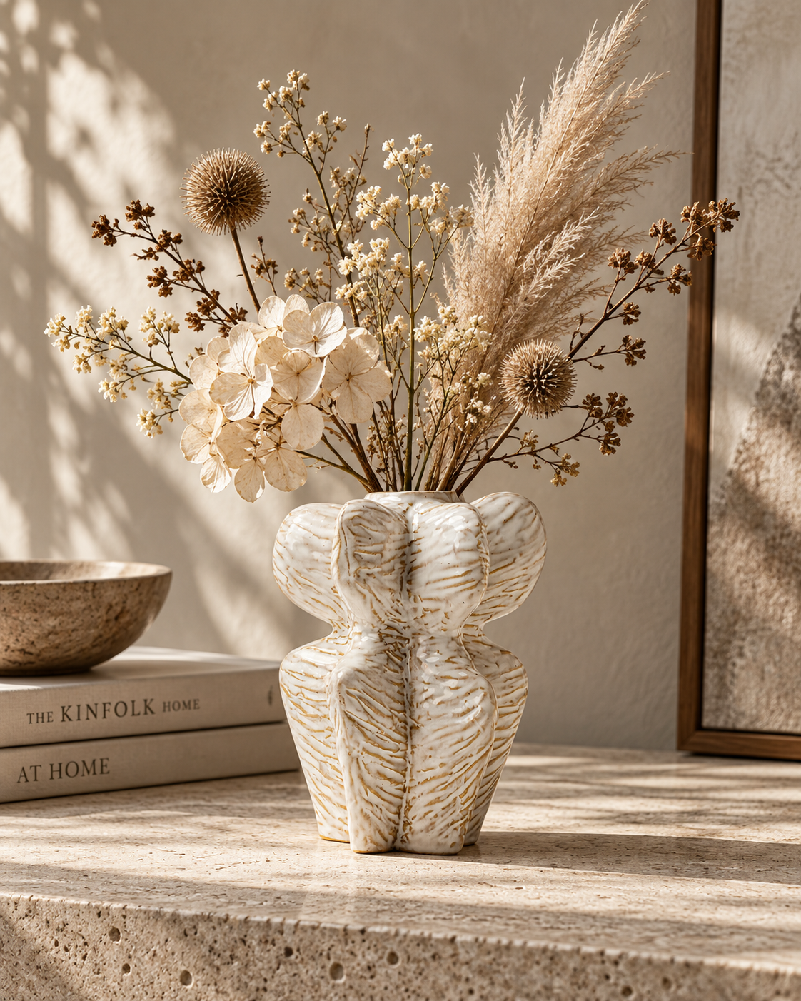 Nia Contour Vase with stems on a tabletop
