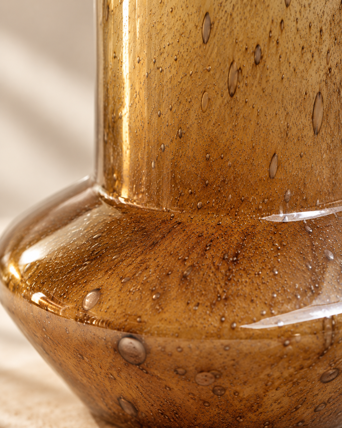 Thea Column Vase close-up showing amber tone with fine darker markings
